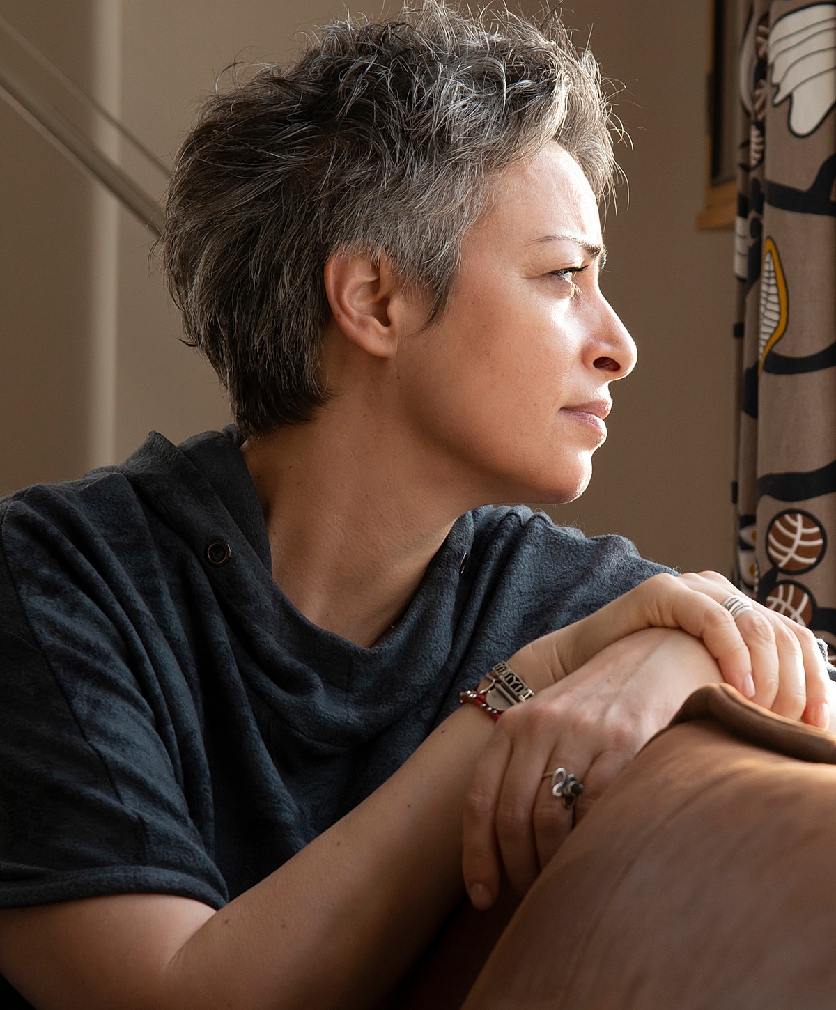 Thoughtful woman gazing out a window.