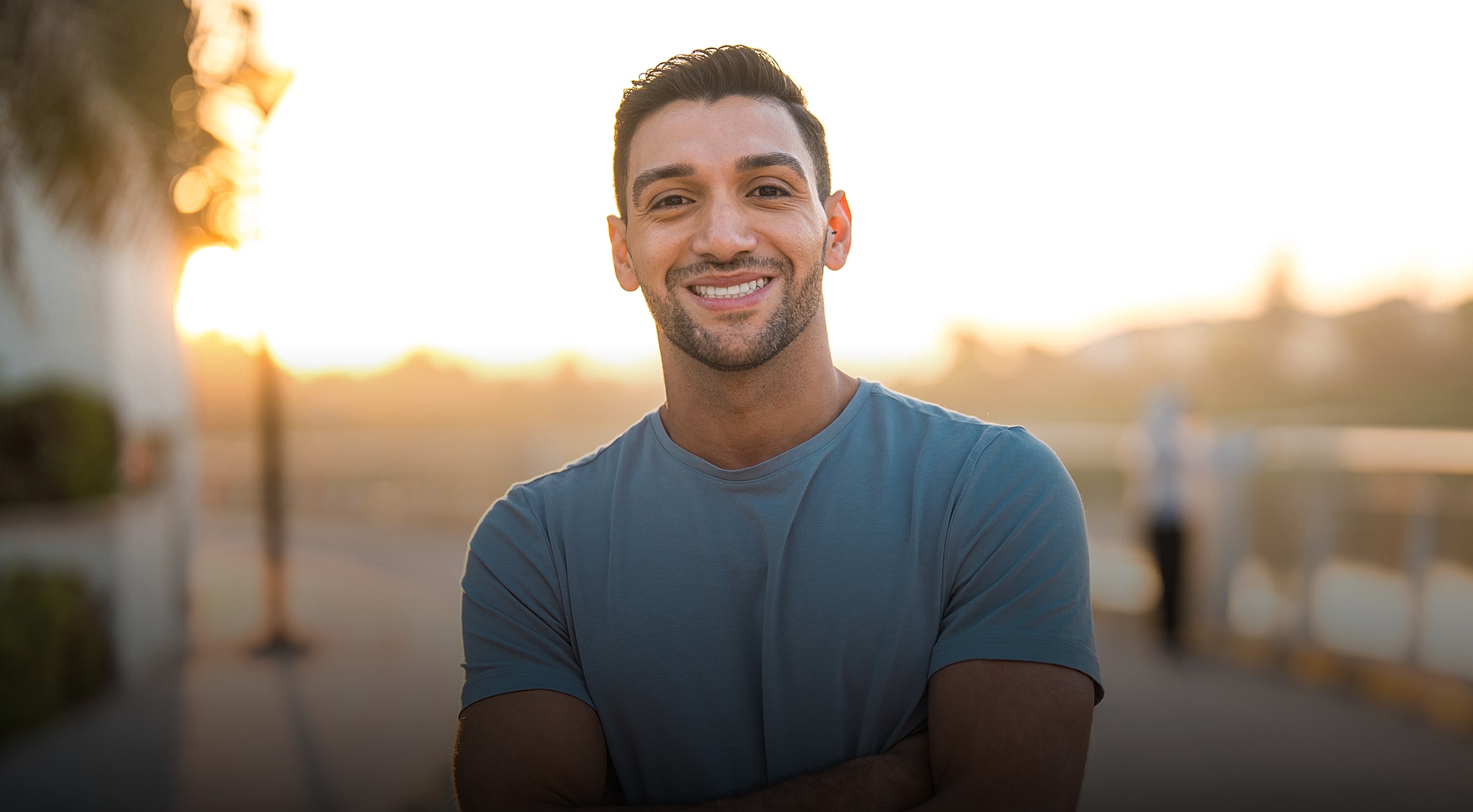 Smiling man in casual attire, cozy environment.